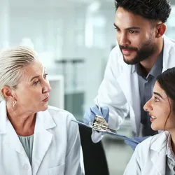 A trio of laboratory staff representing different age generations