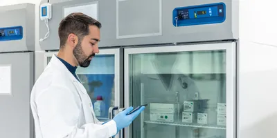 Lab manager checking materials in a supply freezer