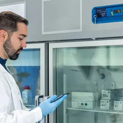 Lab manager checking materials in a supply freezer