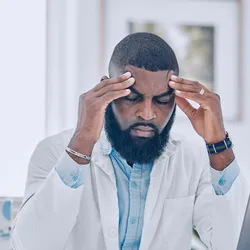 Lab technician showing signs of workplace stress