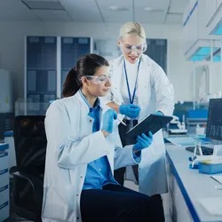 Scientists discussing electronic lab notebooks in a lab setting