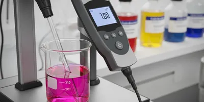 Laboratory setup with a pH meter and colorful solutions
