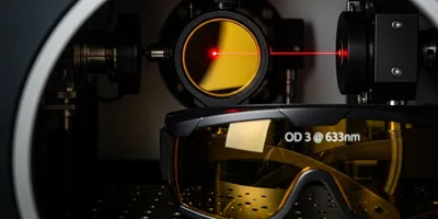 Close-up of HeNe laser and protective eyewear for laser safety.