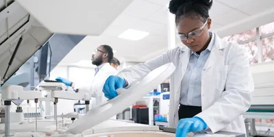 Female medical worker wearing lab coat while working in laboratory