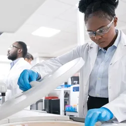 Female medical worker wearing lab coat while working in laboratory