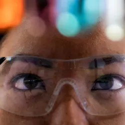 Close-up of a chemist prepared for AI-assisted experimentation.