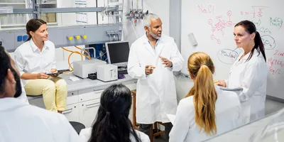 Lab team engaged in a discussion about safety awareness