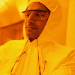 Researcher examining a semiconductor wafer in a lab