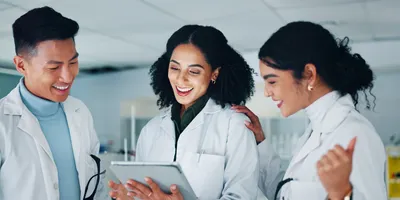 Lab team members collaborating in a supportive environment promoting emotional safety.