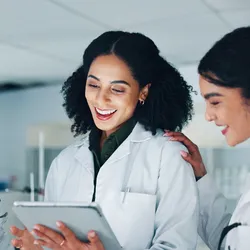 Lab team members collaborating in a supportive environment promoting emotional safety.