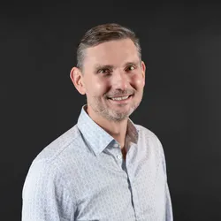 Headshot of Andrew Wyatt on black background