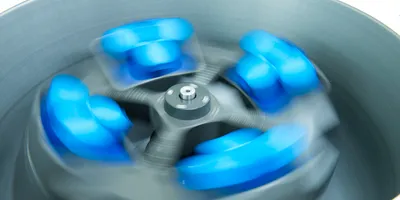 Laboratory centrifuge with swing-bucket rotor in motion processing multi-liter samples for bioprocess scale-up applications