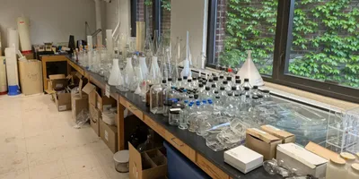 Table filled with various lab equipment and glassware promoting lab equipment reuse.