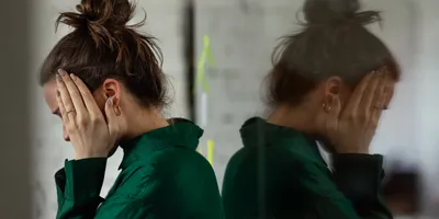 Person exhibiting signs of stress related to workplace bullying