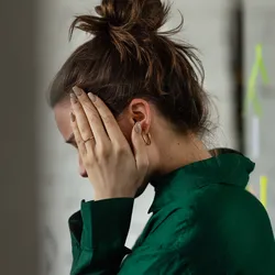 Person exhibiting signs of stress related to workplace bullying