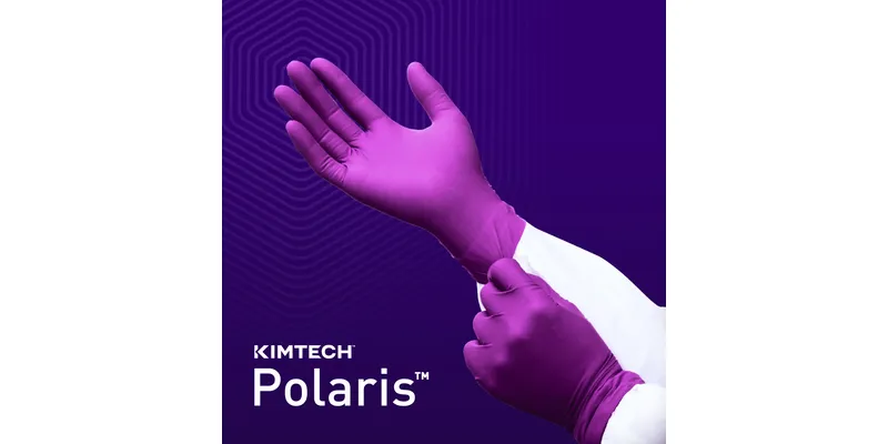 A scientist wearing a white lab coat pulls on a purple Kimtech Polaris nitrile exam glove against a dark purple background featuring a subtle honeycomb pattern and the white Kimtech Polaris logo.