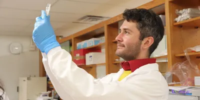 Researcher examining samples in a lab for AI cell tracking