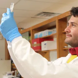 Researcher examining samples in a lab for AI cell tracking