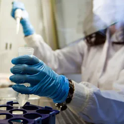 Forensic scientist handling samples in a lab related to drug exposure