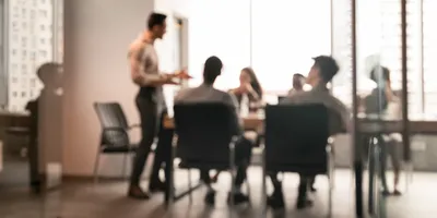 Manager discussing with team in a meeting room