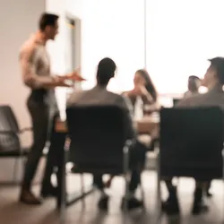 Manager discussing with team in a meeting room