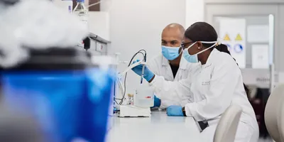 Two scientists working together in the lab, representing safety training during onboarding