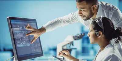 Researchers collaborating on AI data analysis in a laboratory