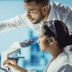 Researchers collaborating on AI data analysis in a laboratory