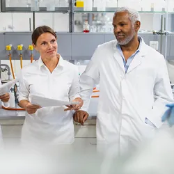Five laboratory staff having a group meeting in the lab.