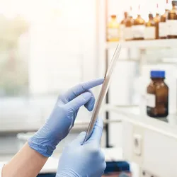 scientist taking inventory of laboratory supplies