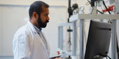 Lab technician analyzing data using AI