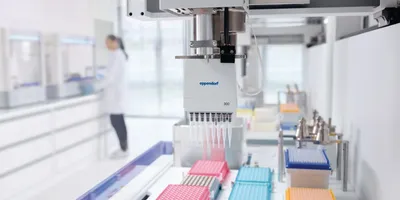 Automated Eppendorf liquid handling robot dispensing into colorful multi-well plates