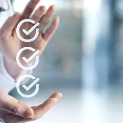 Three checkmarks with hands around them, representing regulatory compliance