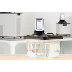 A PolyScience immersion circulator mounted on a clear water bath tank.