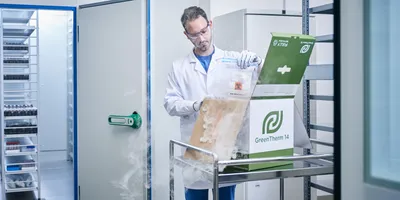 Scientist loading a sample into an Intelsius GreenTherm recyclable shipper.