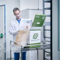 Scientist loading a sample into an Intelsius GreenTherm recyclable shipper.