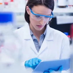 Female lab technician implementing EHS strategy