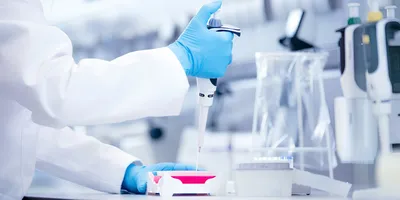 Scientist using a pipette at a lab bench