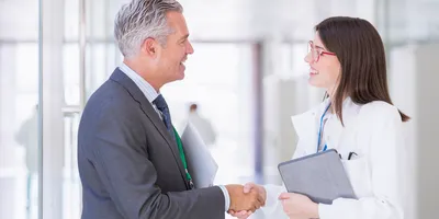 Handshake representing innovation and partnership in research.