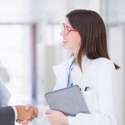 Handshake representing innovation and partnership in research.