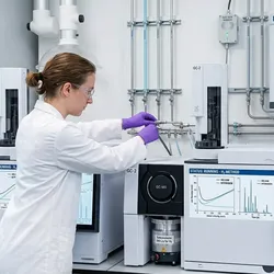 Scientist validating a GC-MS system transitioning from helium to on-site hydrogen and nitrogen carrier gas generators.