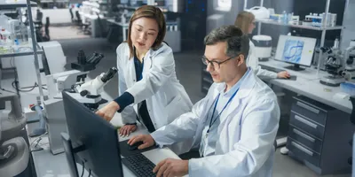 Scientists collaborating in a laboratory setting on AI-related projects