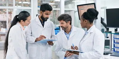 Lab manager leading a team meeting focused on continuous improvement