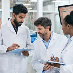 Lab manager leading a team meeting focused on continuous improvement