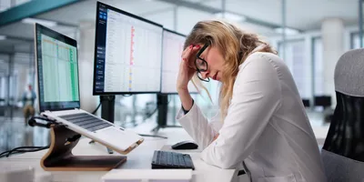 Stressed lab professional reflecting low US job market confidence