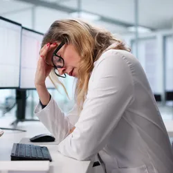 Stressed lab professional reflecting low US job market confidence