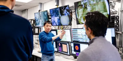 Researchers collaborating on imaging data analysis using AI