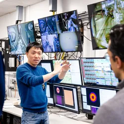 Researchers collaborating on imaging data analysis using AI