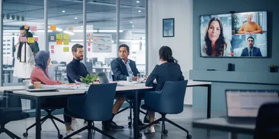 Hybrid work meeting with team engaging remotely and in-person