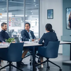 Hybrid work meeting with team engaging remotely and in-person